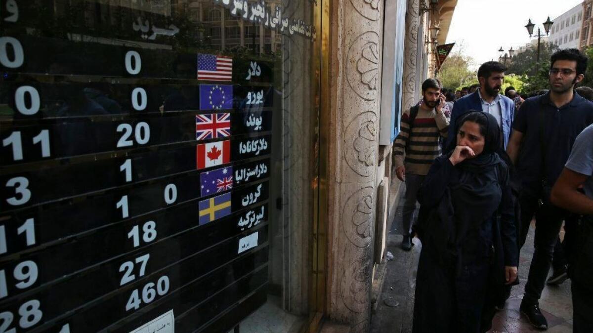 In this Oct. 2 file photo, an exchange shop displays rates for various currencies in downtown Tehran.