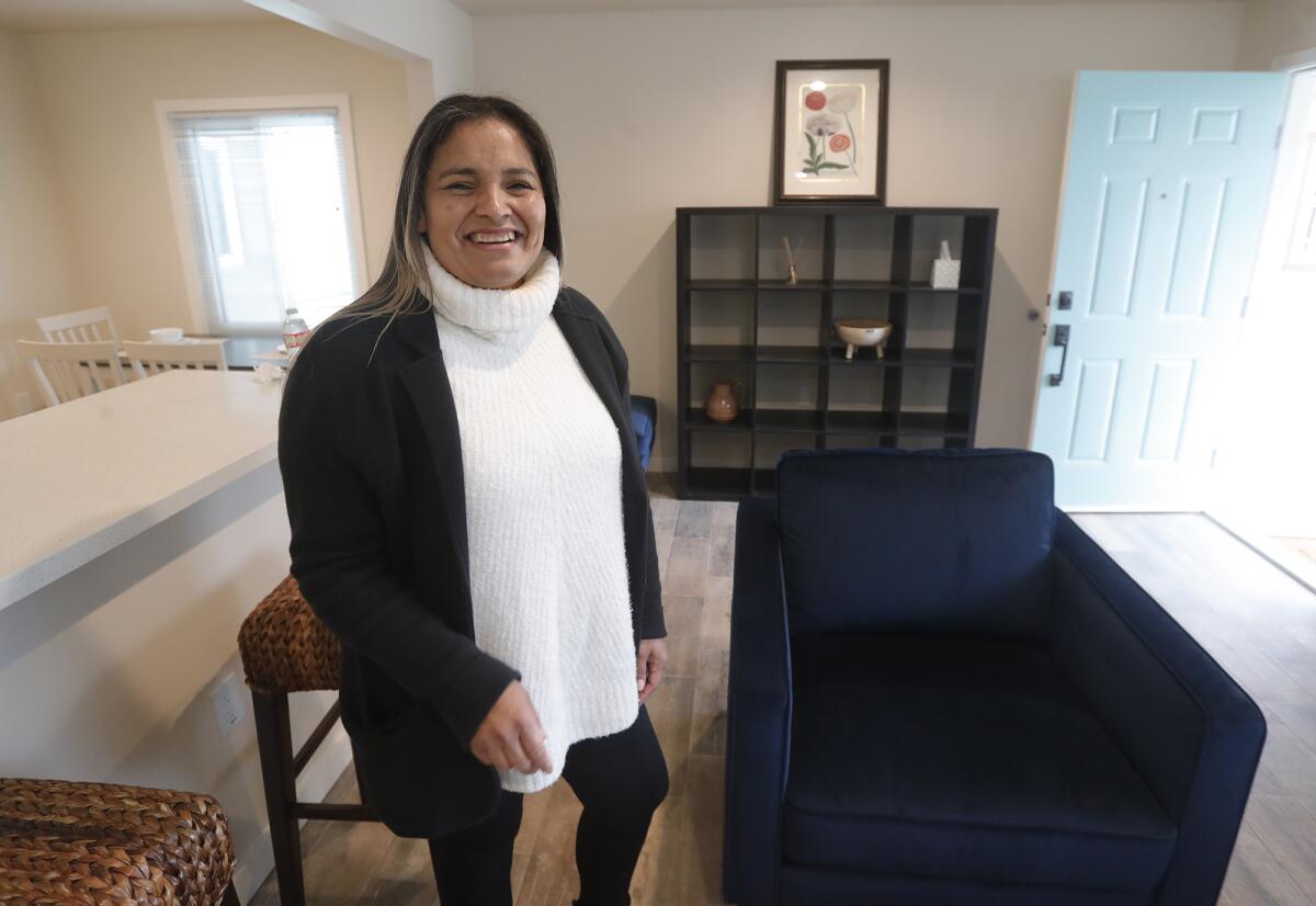 Families Forward client and success story Erika Lopez stands inside a new unit at The Bungalows in Costa Mesa on Thursday.