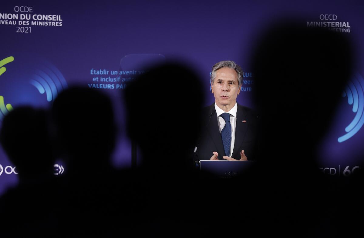 Secretary of State Antony Blinken speaking to a group from a lectern 