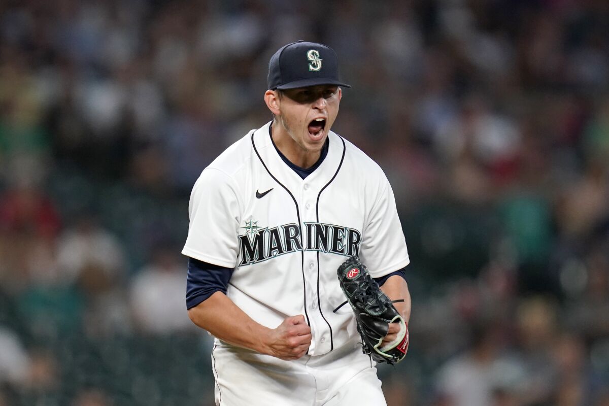 Seattle Mariners starting pitcher Chris Flexen yells after striking out Los Angeles Angels' Taylor Ward to end the top of the seventh inning of a baseball game Saturday, July 10, 2021, in Seattle. (AP Photo/Elaine Thompson)