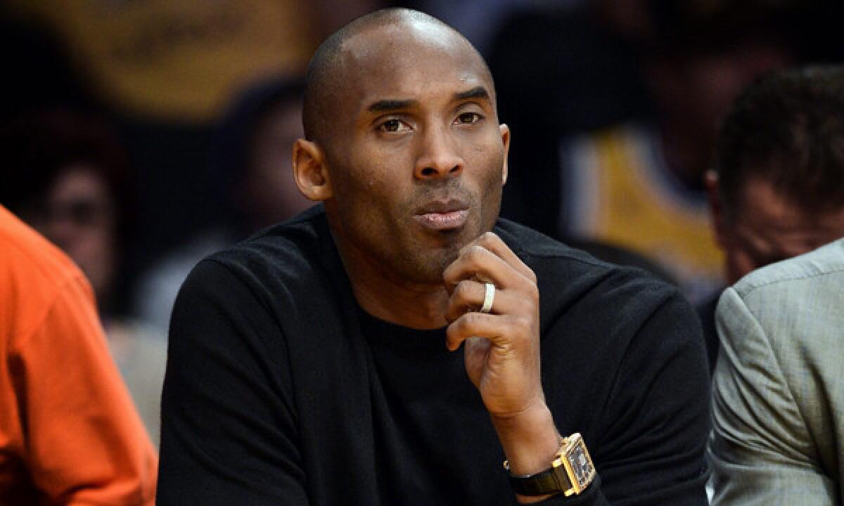 Injured Lakers star Kobe Bryant looks on from the bench as his team plays the Milwaukee Bucks at Staples Center.
