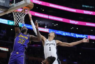 Los Angeles Lakers forward LeBron James (23) vies for a rebound against San Antonio Spurs.
