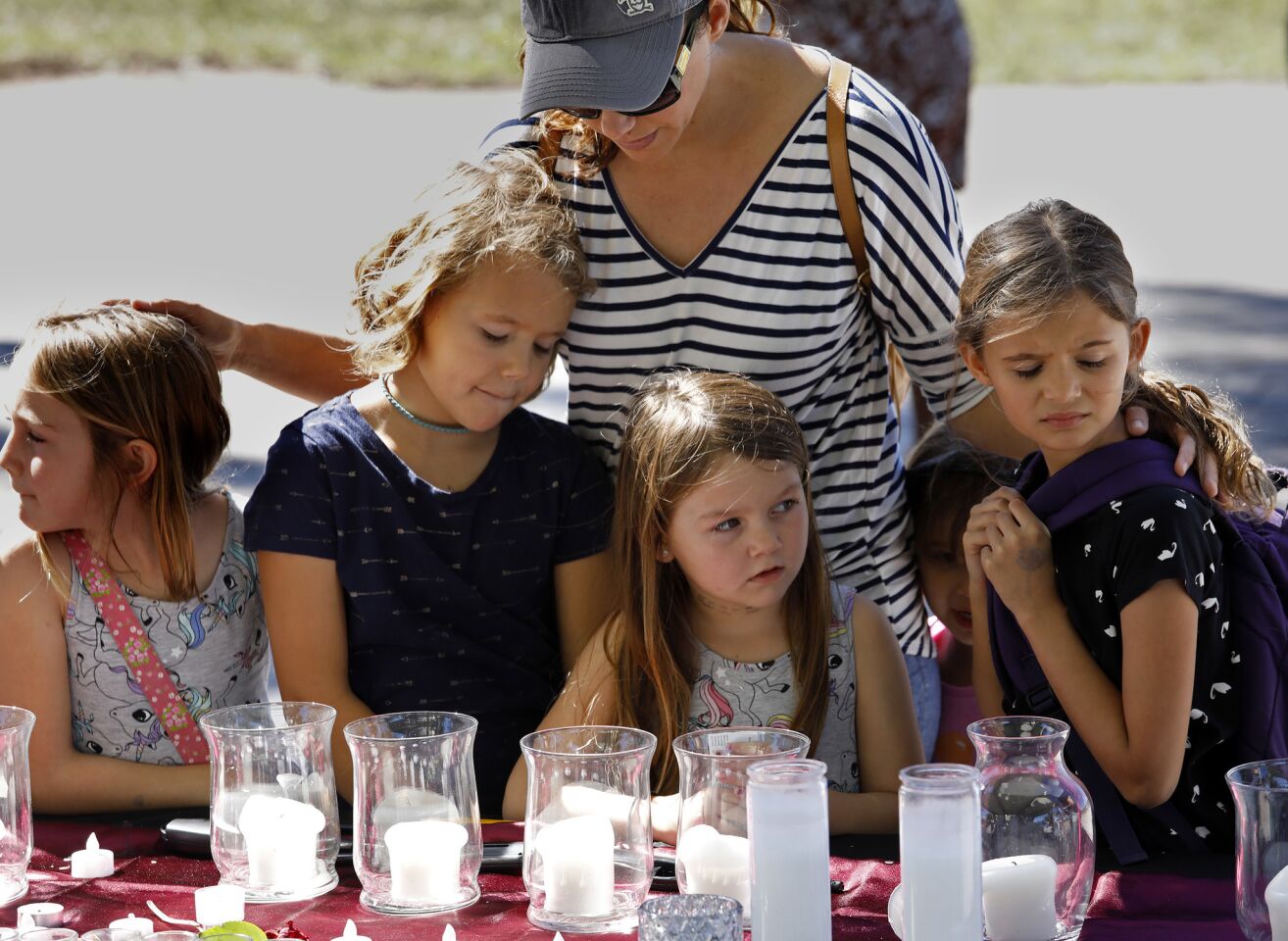 Sarah Cardenas, age 38, brings some of her students from Classical Conversation (home school) in Boca Raton to the memorial for the victims of the shooting at Marjorie Stonemason Douglas High School in Parkland, Florida where a gunman killed 17 dead and injured 14 in a school shooting. "We came to pay our respects and pray," says Cardenas. (Carolyn Cole/Los Angeles Times)