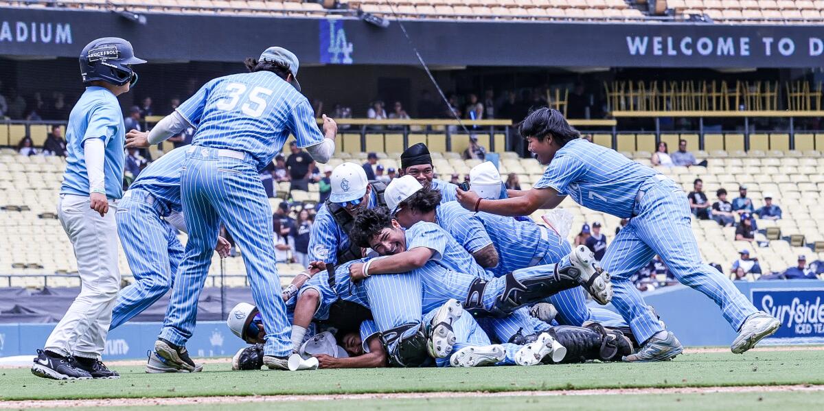 Carson players form a dogpile as they celebrate after a 3-1 win over Banning at Dodger Stadium.