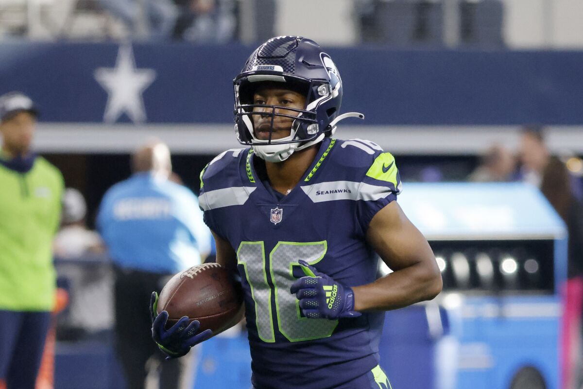 Seattle Seahawks wide receiver Tyler Lockett (16) warms up prior to a preseason NFL Football game in Arlington, Texas, Friday, Aug. 27, 2022. (AP Photo/Michael Ainsworth)