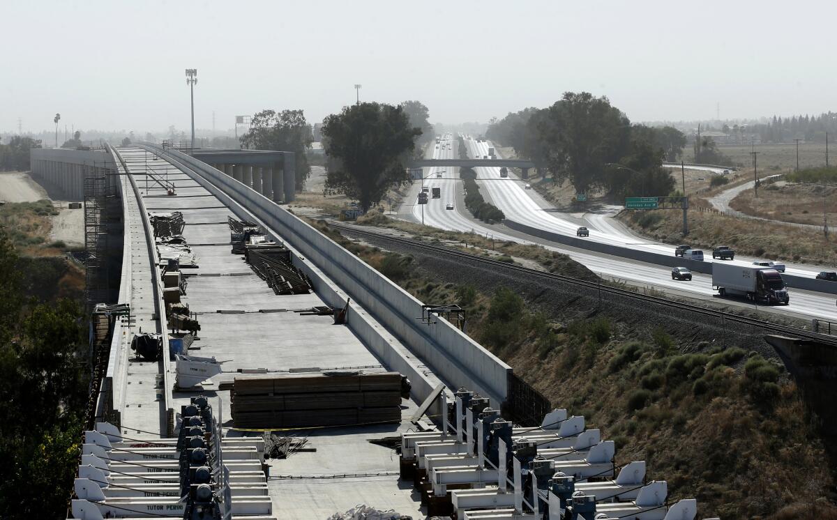 A high-speed rail viaduct is shown parallel to Highway 99 near Fresno.