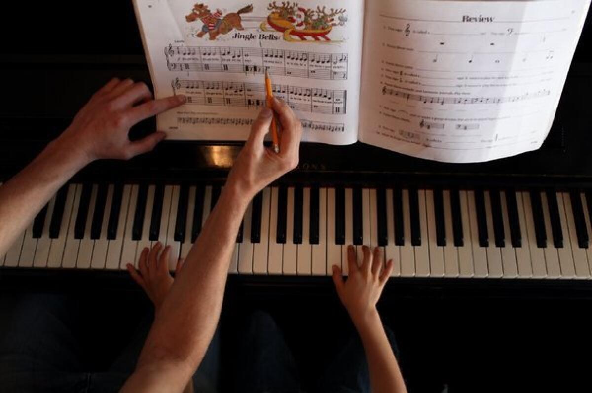 A student learns "Jingle Bells" at the Neighborhood Music School in Boyle Heights.