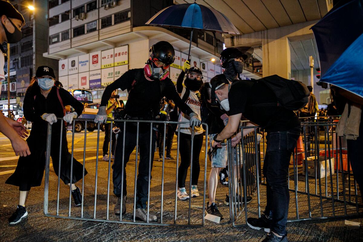Protesters set up road blocks on Nathan Road, a busy main street, outside the Mong Kok police station.