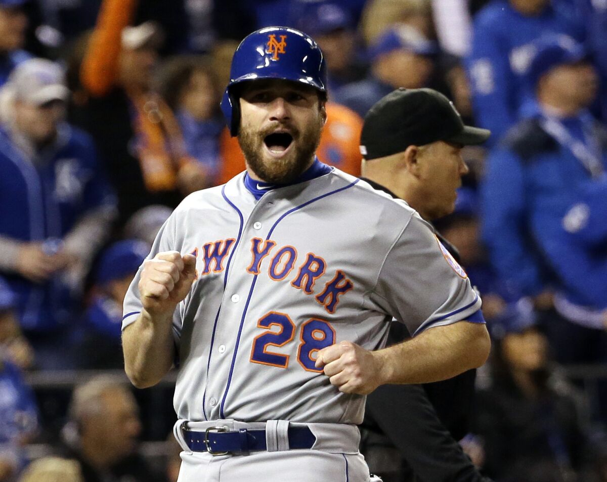 FILE - New York Mets' Daniel Murphy reacts as he scores from second on a hit by Lucas Duda during the fourth inning of Game 2 of baseball's World Series against the Kansas City Royals on, Oct. 28, 2015, in Kansas City, Mo. The Mets announced Tuesday, Feb. 8, 2022, the return of Old-Timers Day for the first time since 1994. (AP Photo/David J. Phillip, File)
