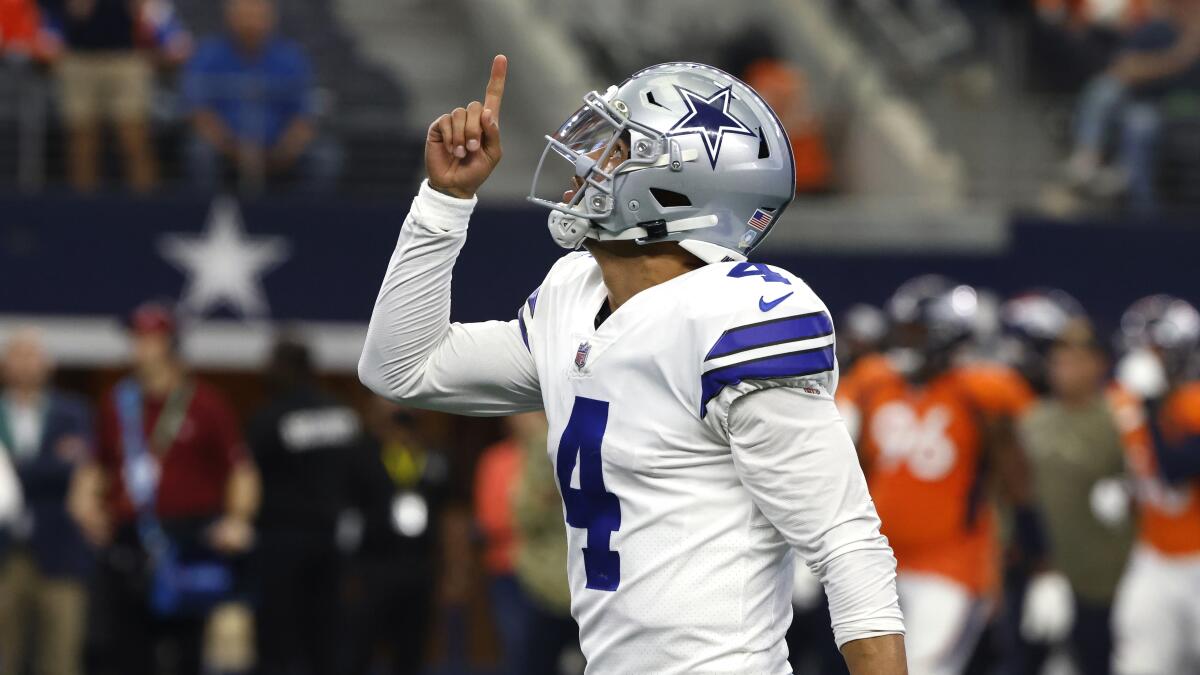 Dallas Cowboys quarterback Dak Prescott reacts after throwing a touchdown pass against the Denver Broncos.