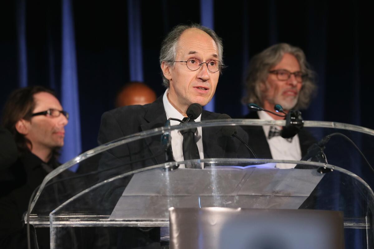 Charlie Hebdo editor-in-chief Gerard Biard accepts PEN/Toni and James C. Goodale Freedom of Expression Courage Award onstage Tuesday night. With him are Charlie Hebdo film critic Jean-Baptiste Thoret, left, and New Yorker cartoon editor Bob Mankoff, right, at the PEN American Center Literary Gala at American Museum of Natural History in New York.
