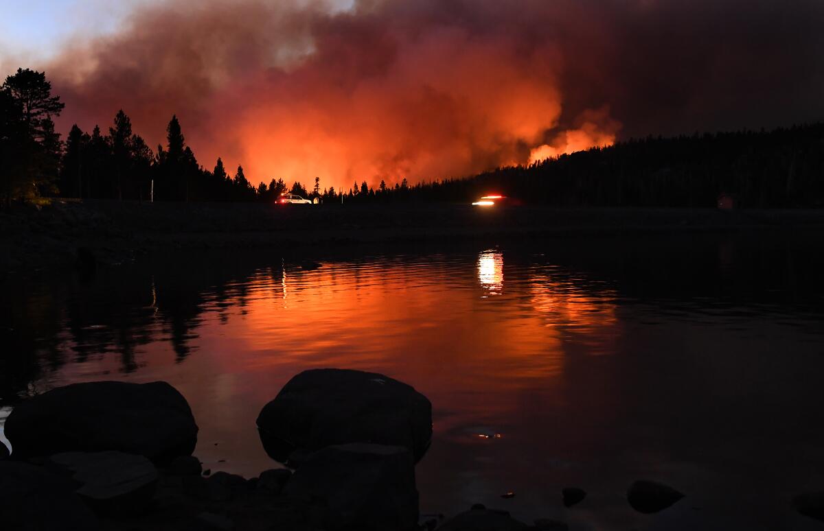 Caldor fire is reflected off Caples Lake near Kirkwood ski resort Wednesday.