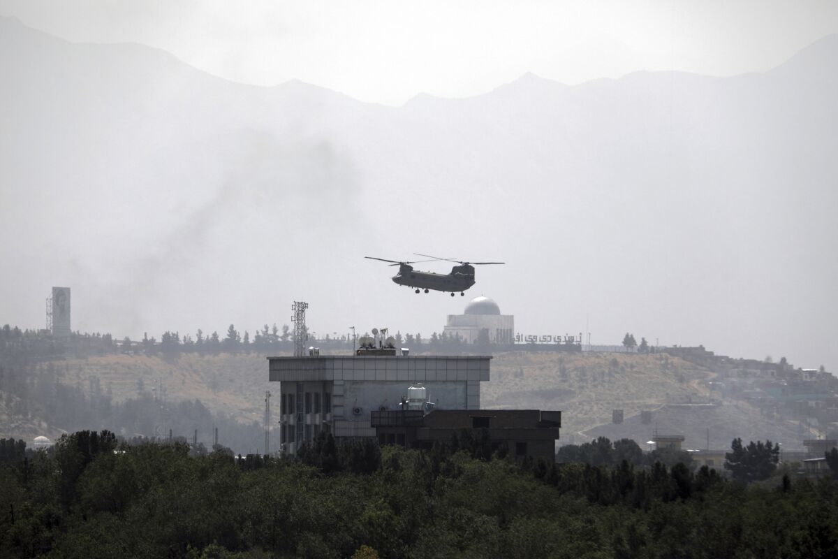 A U.S. Chinook helicopter flies over the U.S. Embassy in Kabul
