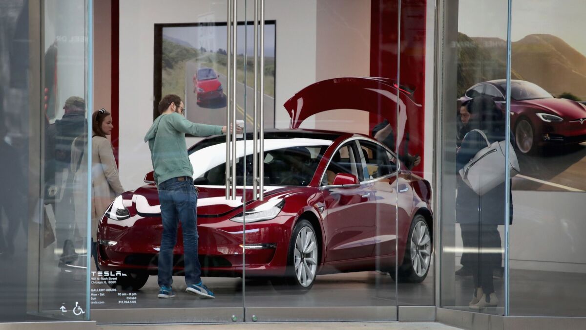 A Model 3 is shown at a Tesla dealership in Chicago.