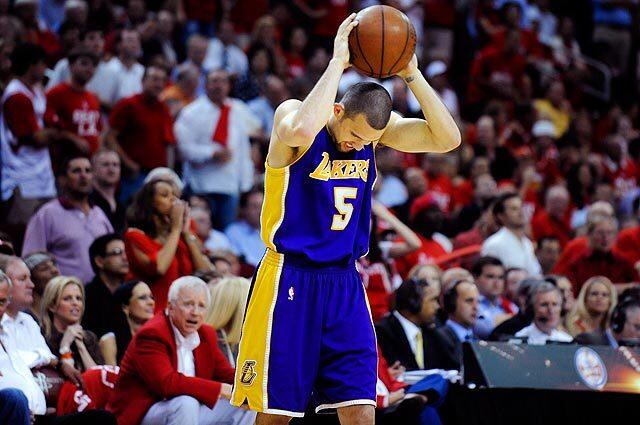 Lakers Jordan Farmar holds the ball in disgust while losing to the Rockets in Game 6 of the Western Conference semifinal series in Houston.