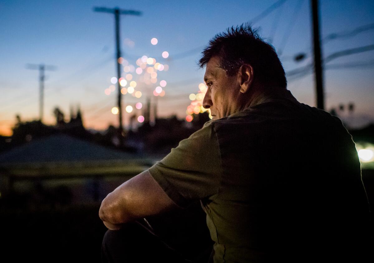 A week after his release, Jose Garcia watches fireworks from his rooftop in Arleta on July 4, 2018.