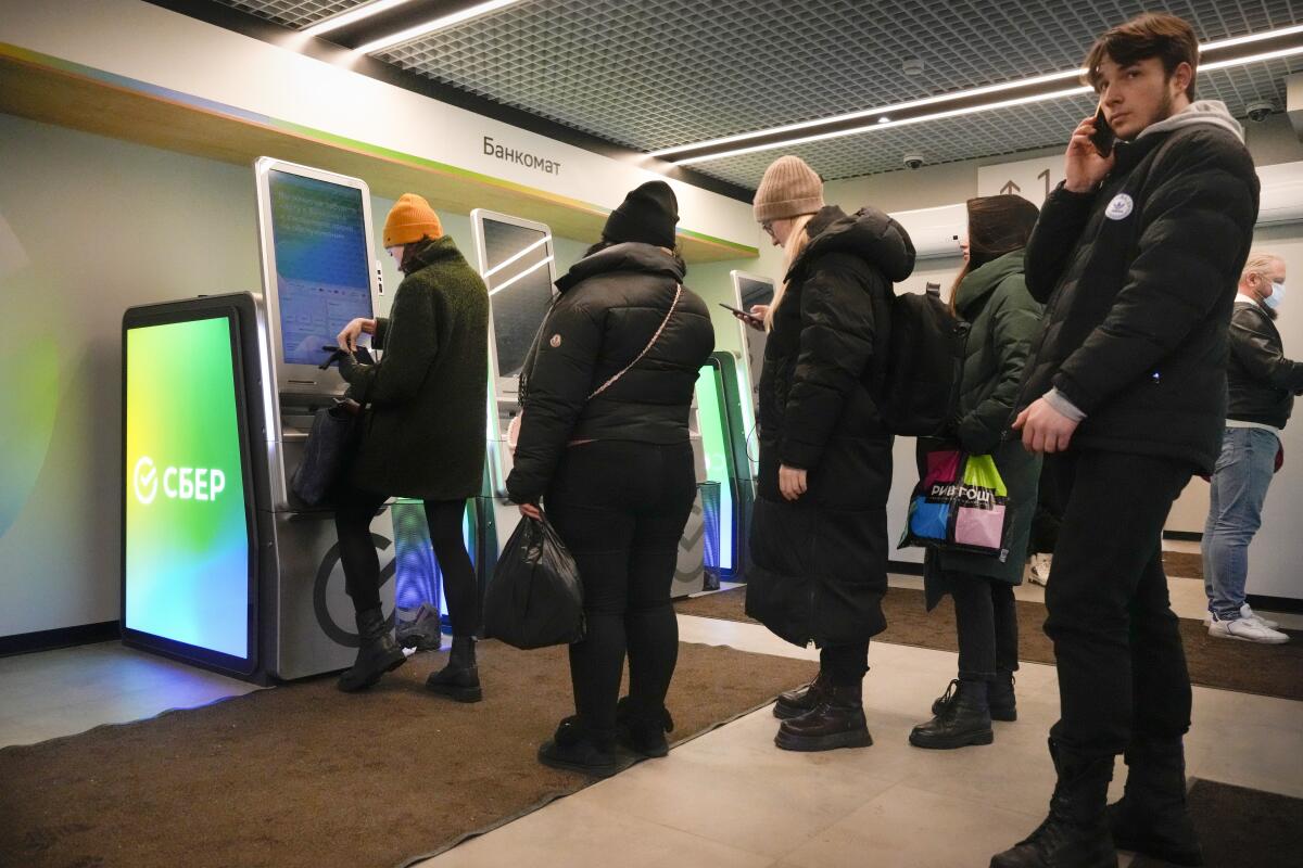 Russians wait in line at a bank.