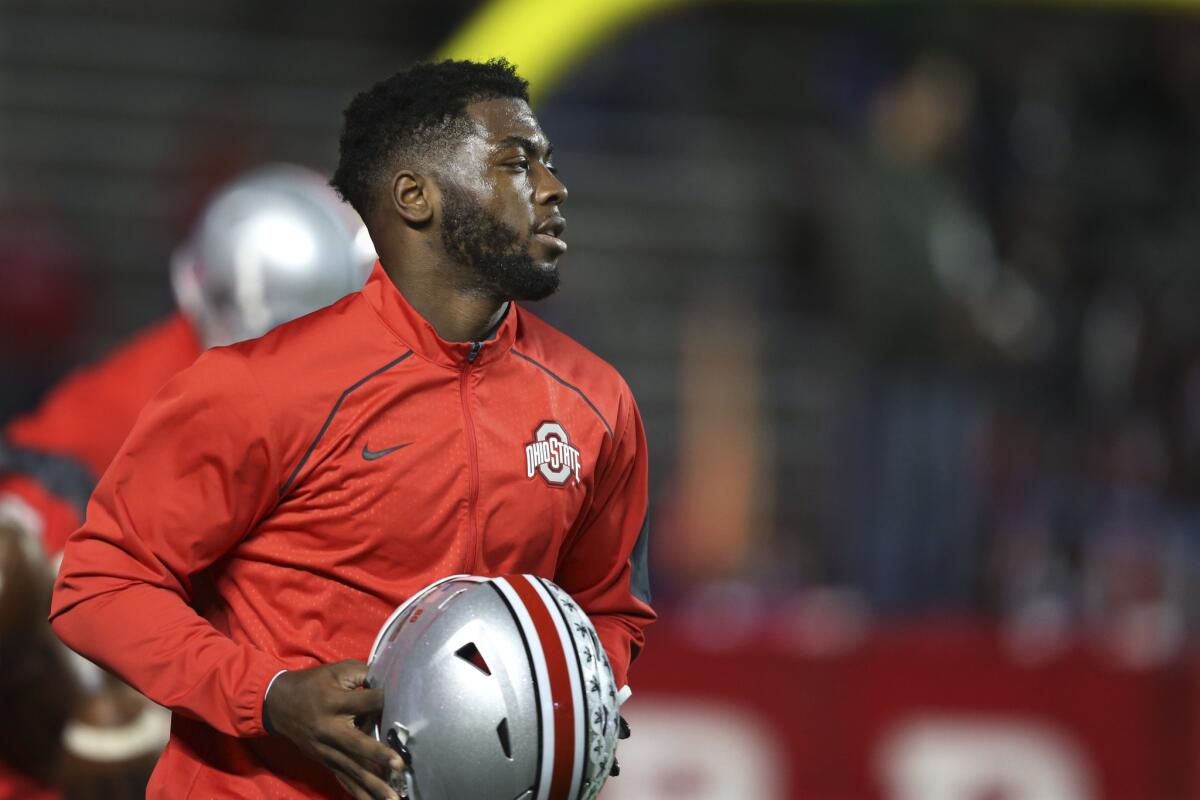 Ohio State quarterback J.T. Barrett holds his helmet during warmups before a game against Rutgers.