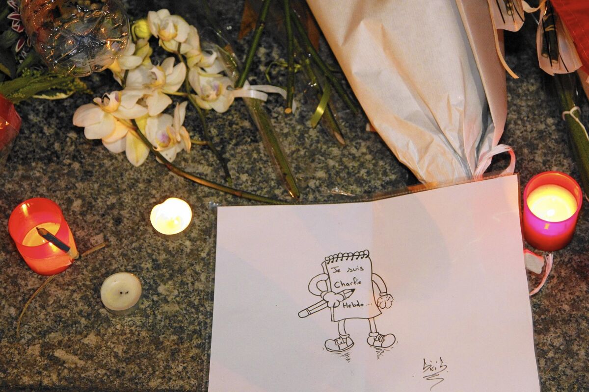 A drawing that reads, “I am Charlie Hebdo” is among the tributes to the slain journalists near the offices of the French satirical magazine.