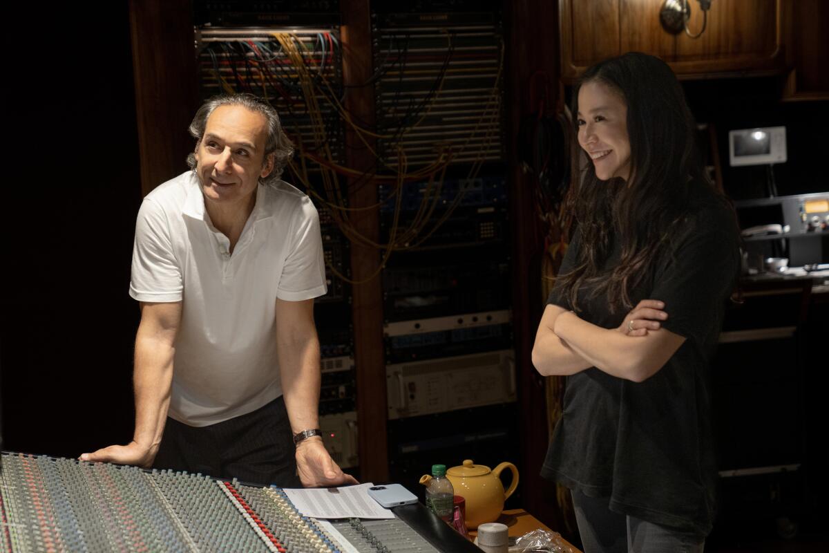 Composer Alexandre Desplat and co-director Elizabeth Chai Vasarhelyi at a scoring session for "Nyad."