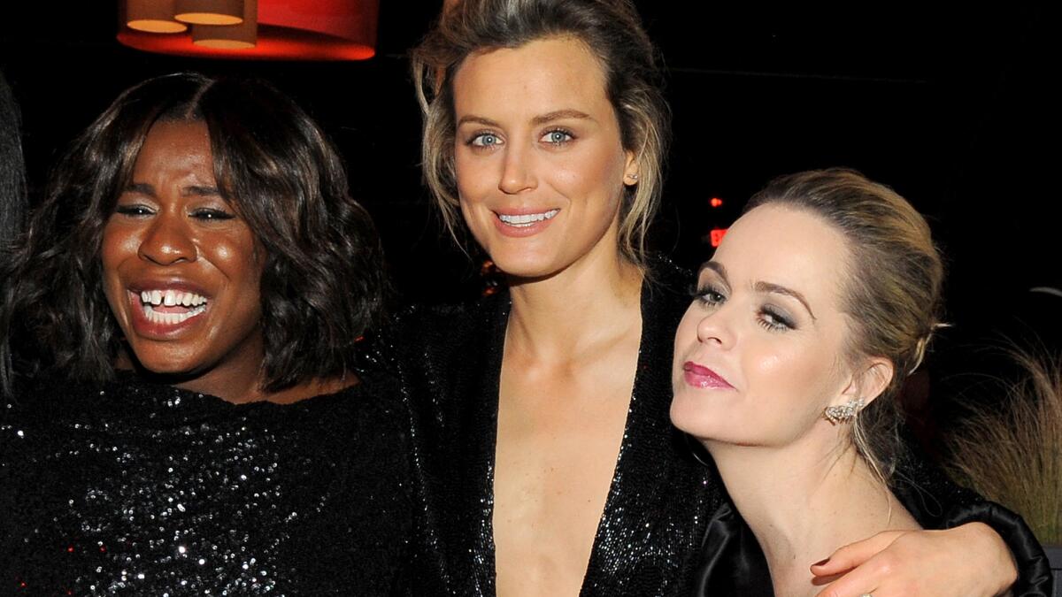 Supporting TV actress nominee Uzo Aduba, left, Taylor Schilling and Taryn Manning of "Orange Is the New Black" attend the Weinstein Co. and Netflix Golden Globes party.