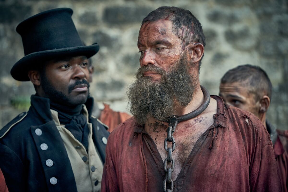 David Oyelowo, left, as Inspector Javert and Dominic West as Jean Valjean in "Les Miserables."