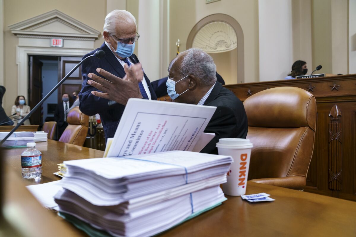 Rep. Bill Pascrell, D-N.J., left, and Rep. Danny Davis, D-Ill., confer as the tax-writing House Ways and Means Committee continues working on a sweeping proposal for tax hikes on big corporations and the wealthy to fund President Joe Biden's $3.5 trillion domestic rebuilding plan, at the Capitol in Washington, Tuesday, Sept. 14, 2021. (AP Photo/J. Scott Applewhite)