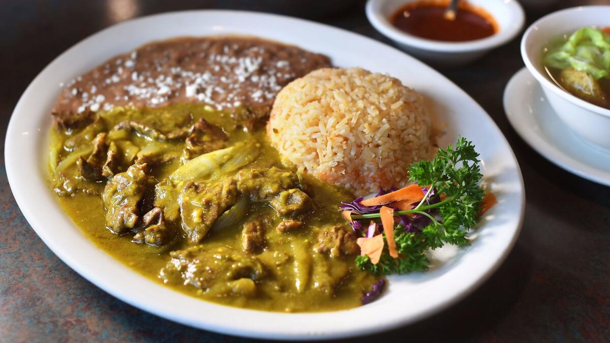 Carne de res en chile verde, diced flank steak in a green hot chile sauce, is served with rice and beans at Teresitas Restaurant in Los Angeles. (Christina House / For The Times)