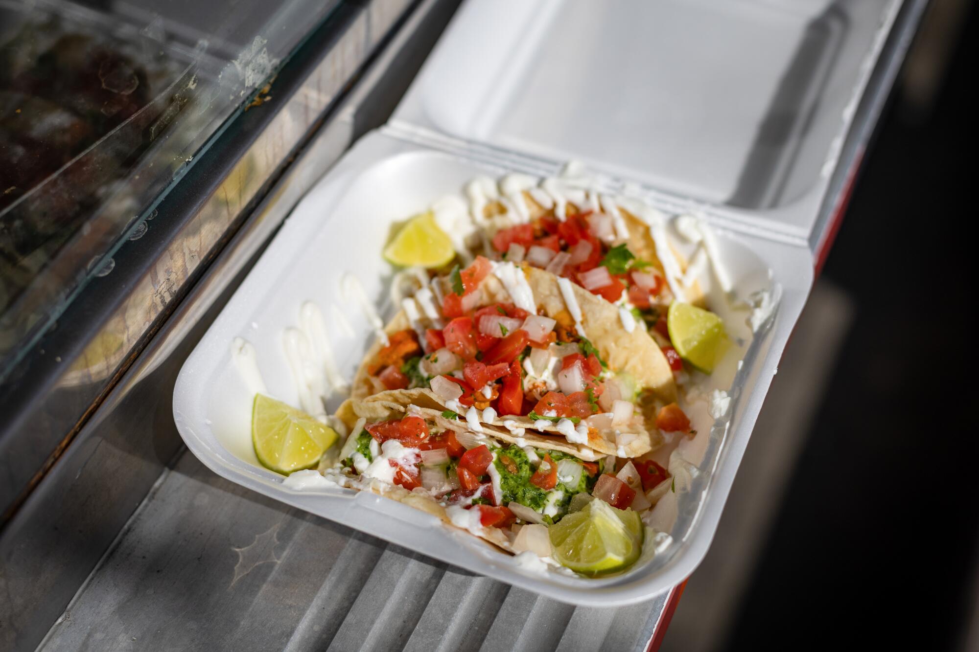 A styrofoam container of tacos at All Flavor No Grease.