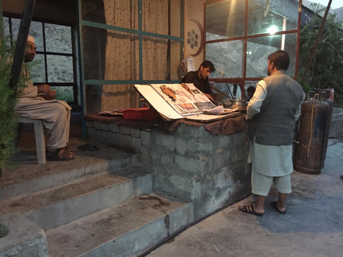 At a roadside restaurant outside Kabul, Gula Jan, far left, sells hashish to a wide array of clients.