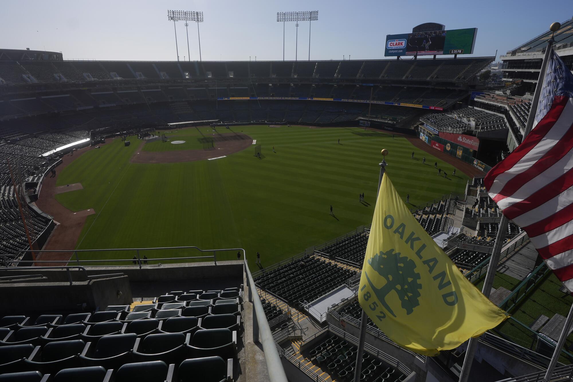 A city of Oakland flag flies at a sports stadium