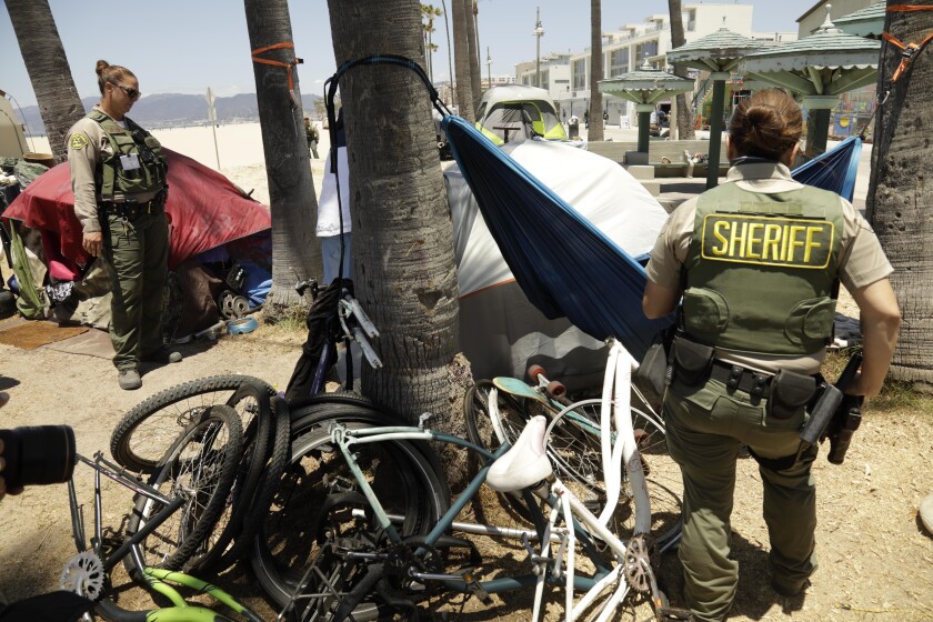 Los Angeles County sheriff's deputies among tents on the beach
