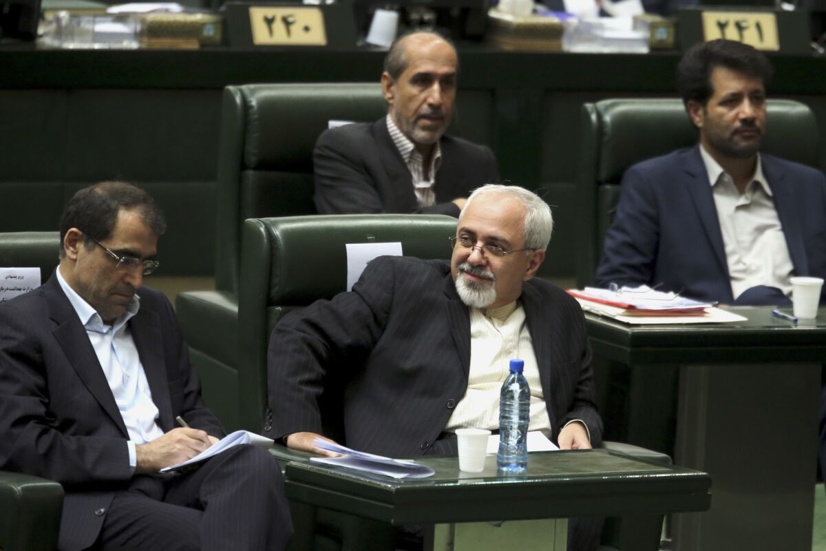 Iranian Foreign Minister Mohammad Javad Zarif, center, will be the new chief delegate to nuclear talks with both the International Atomic Energy Agency and six major powers that include the United States. Analysts saw Thursday's move by Iranian President Hassan Rouhani to take over control of the negotiations from the religious hierarchy as a sign that the new president plans to make good on a campaign promise to improve relations with the West.