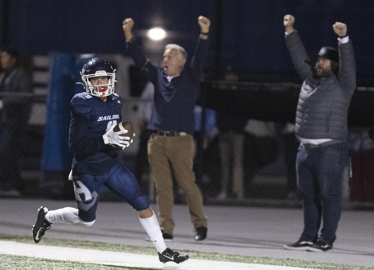 Newport Harbor's Josiah Lamarque scores a touchdown during the Battle of the Bay football game at Davidson Field.