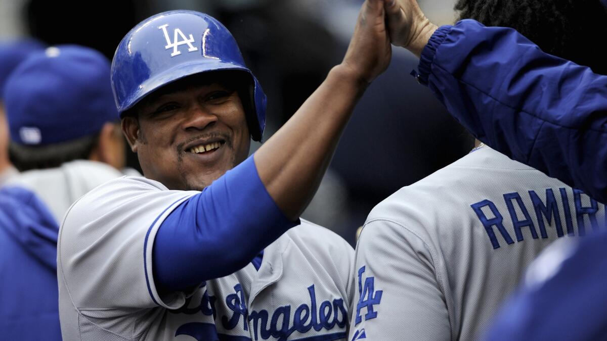 Dodgers third baseman Juan Uribe celebrates after scoring a run against the Minnesota Twins on May 1. Despite frequent trips to the disabled list, Uribe has fulfilled a leadership role for the Dodgers.