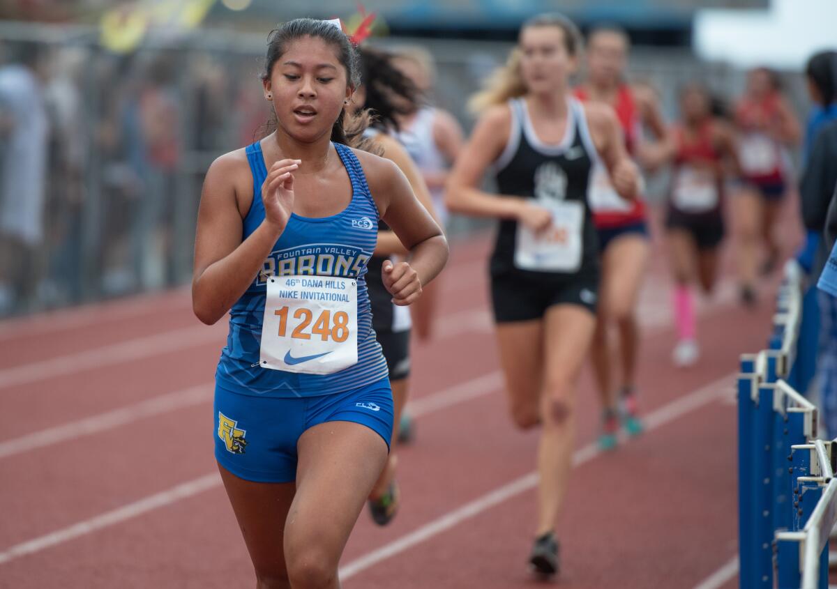 Fountain Valley’s Maddie Jahshan runs through the Dana Hills High stadium in the final stretch of the Dana Hills Invitational sweepstakes race on Sept. 28.