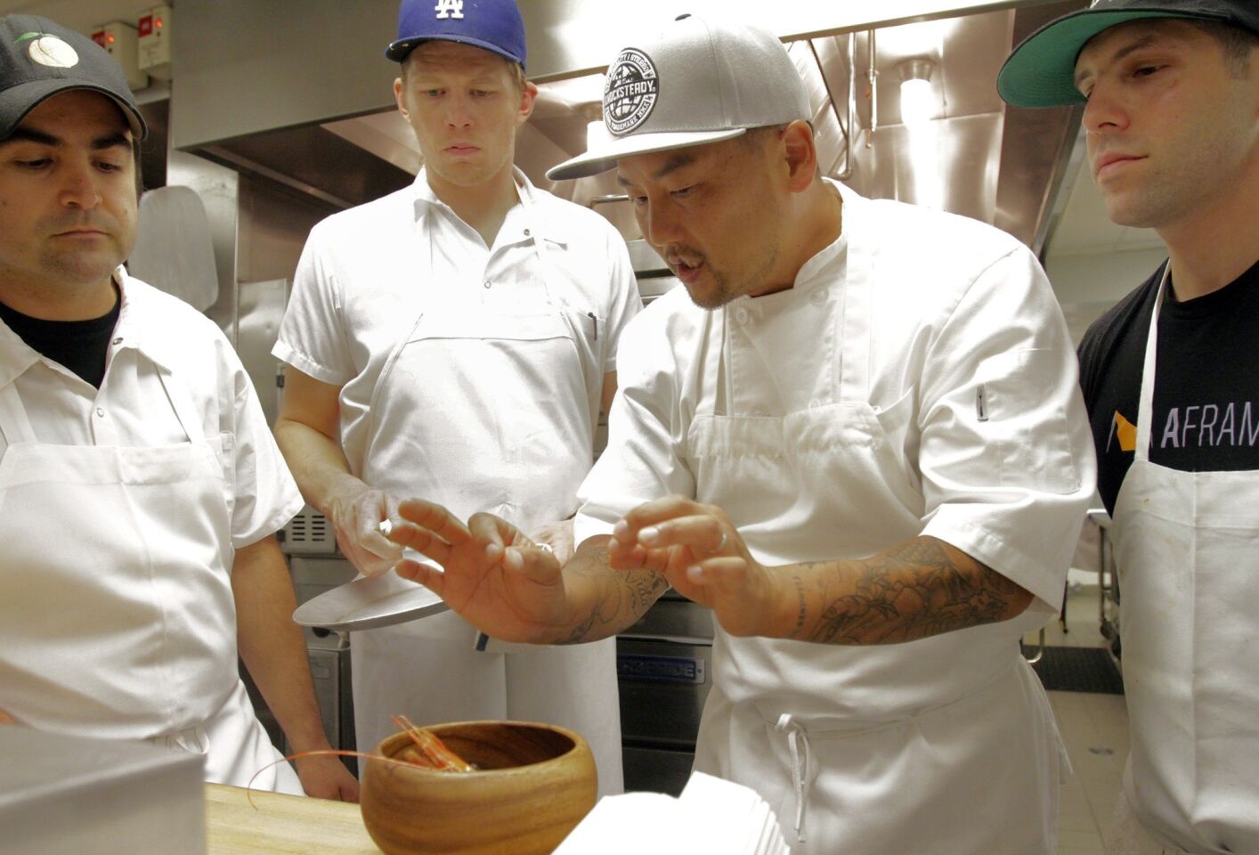 Chef Roy Choi instructs his staff in the kitchen.