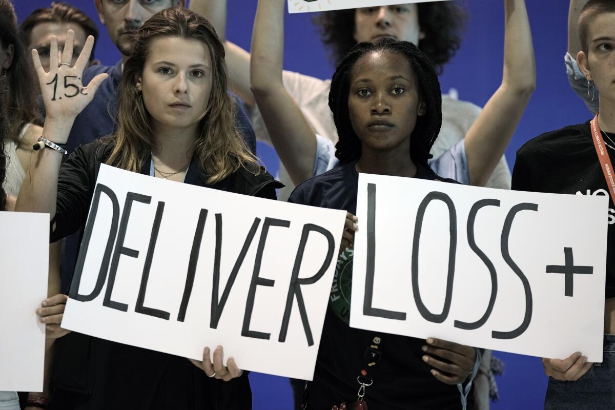 Climate activists hold signs with other youth activists.