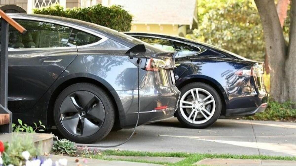 Two Teslas in the driveway of a multimillion-dollar home in Palo Alto.