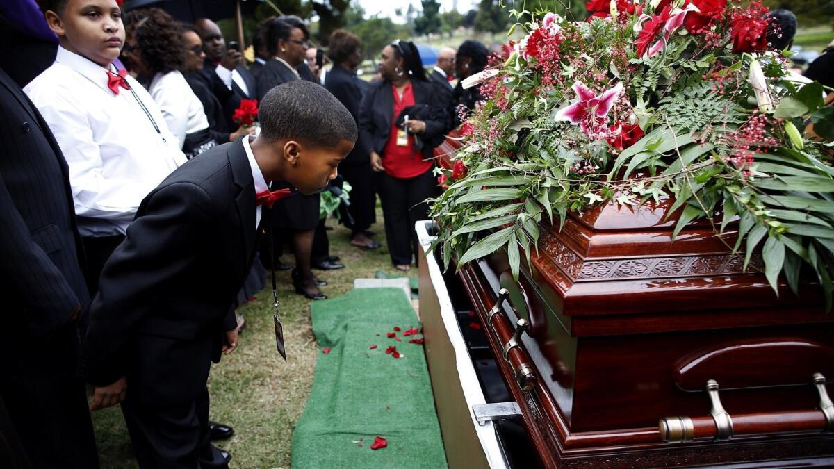 Family members view the coffin of Terry Carter during his funeral service.
