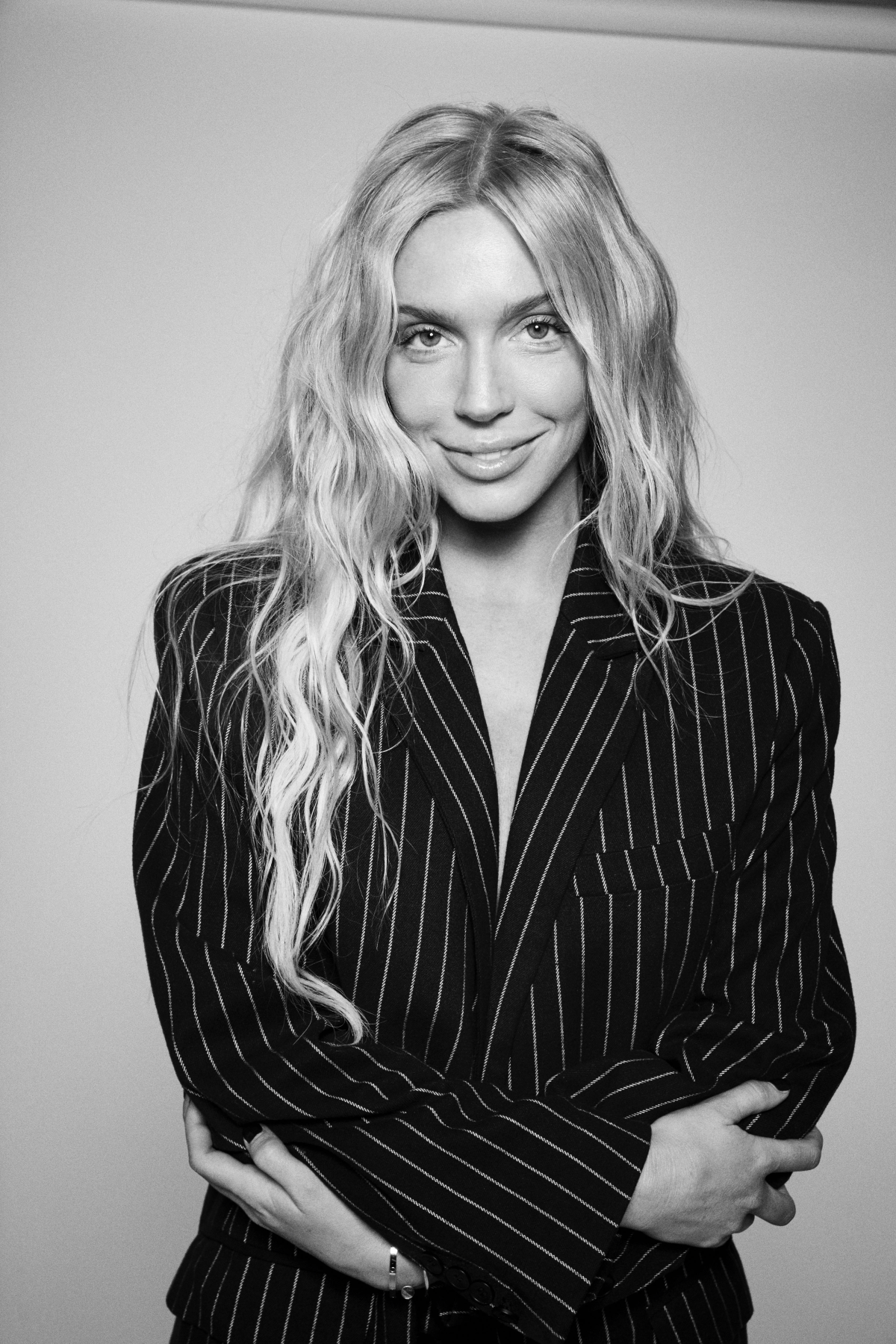 black-and-white photo of a woman posing in a blazer 