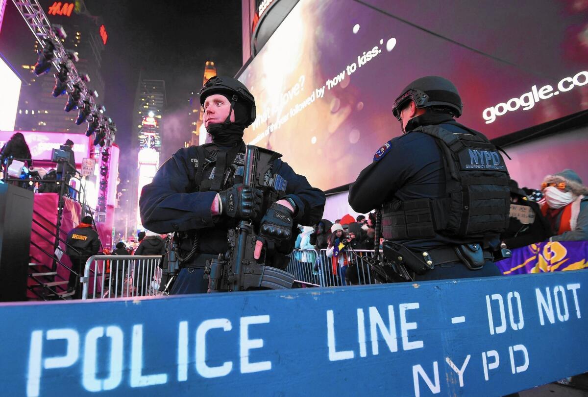 Police officers stand guard over the many revelers in New York last year.