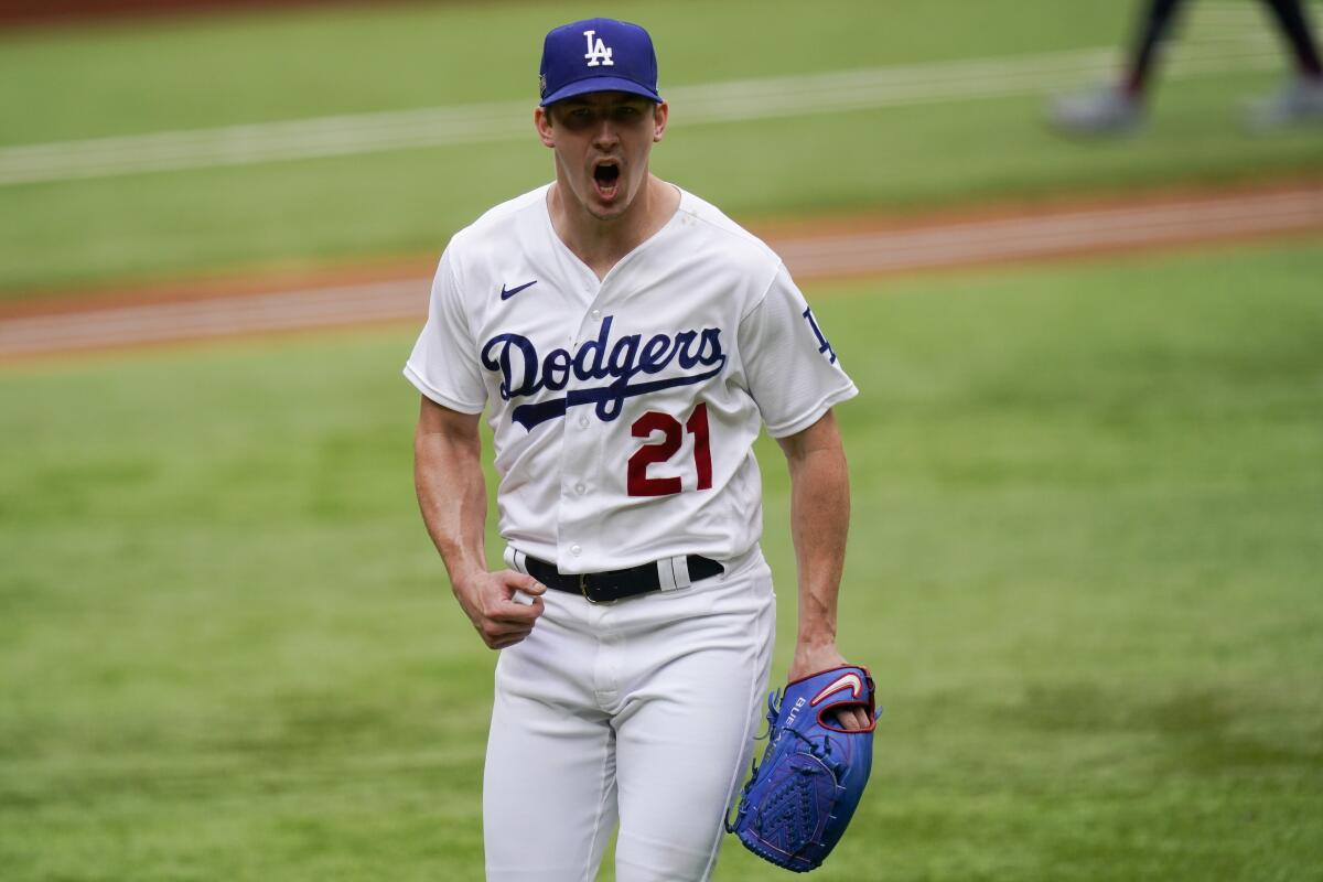 Dodgers starting pitcher Walker Buehler celebrates after getting out of a bases-loaded jam.