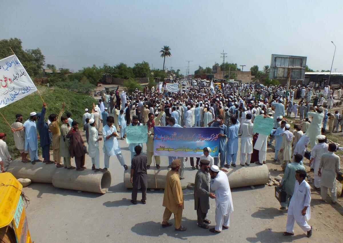 Displaced civilians, fleeing military airstrikes against Taliban militants in North Waziristan, protest in Bannu on Wedesday. Pakistan's military said it has killed 65 militants and destroyed five hideouts near the Afghan border.