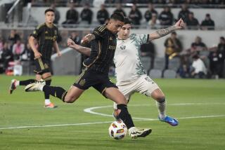 Los Angeles FC forward Cristian Olivera, left, takes a shot on goal as Portland Timbers.