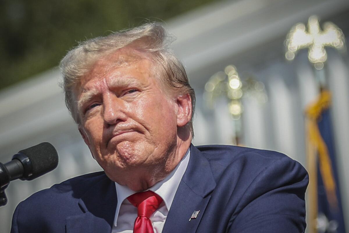 A closeup of former President Trump in front of a microphone