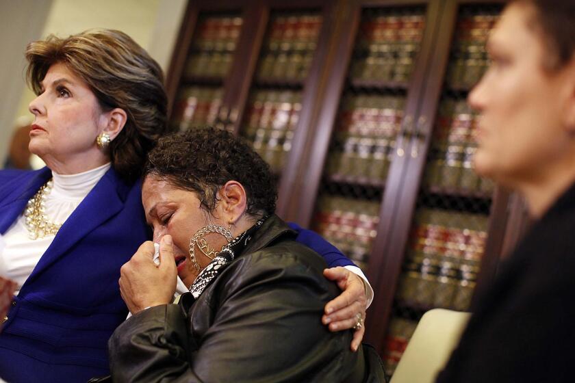 Gloria Allred consoles Chelan (identified only by first name) during a news conference Wednesday. Three victims, Beth Ferrier, Helen Hayes, and Chelan appeared alongside Allred alleging that Bill Cosby attacked them.
