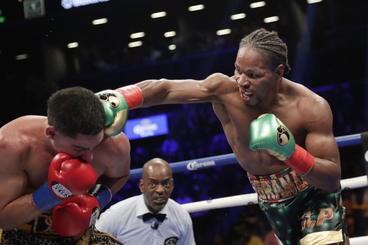 Shawn Porter, right, punches Danny Garcia.