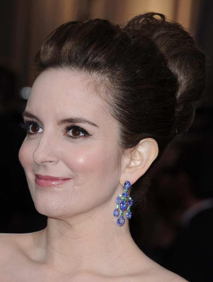 Tina Fey's sapphire and emerald earrings are a fun accent to her classic navy blue Carolina peplum gown.