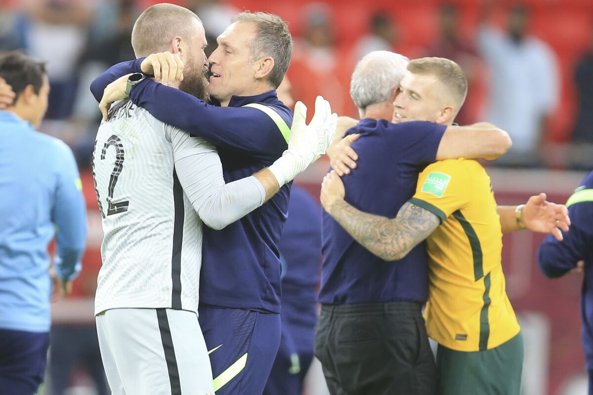 Australian players celebrate after winning in a penalty shoot-out during the World Cup 2022 qualifying play-off soccer match between Australia and Peru in Al Rayyan, Qatar, Monday, June 13, 2022. (AP Photo/Hussein Sayed)